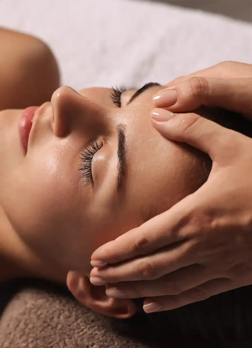 Attractive woman enjoying face massage, closeup. Beauty procedure